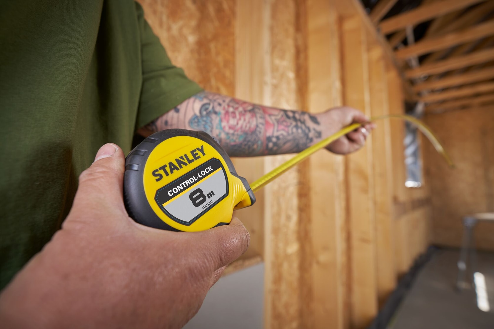 STANLEY® CONTROL-LOCK™ 8M (25mm wide) Tape Measure being used by worker in extended reach to measure