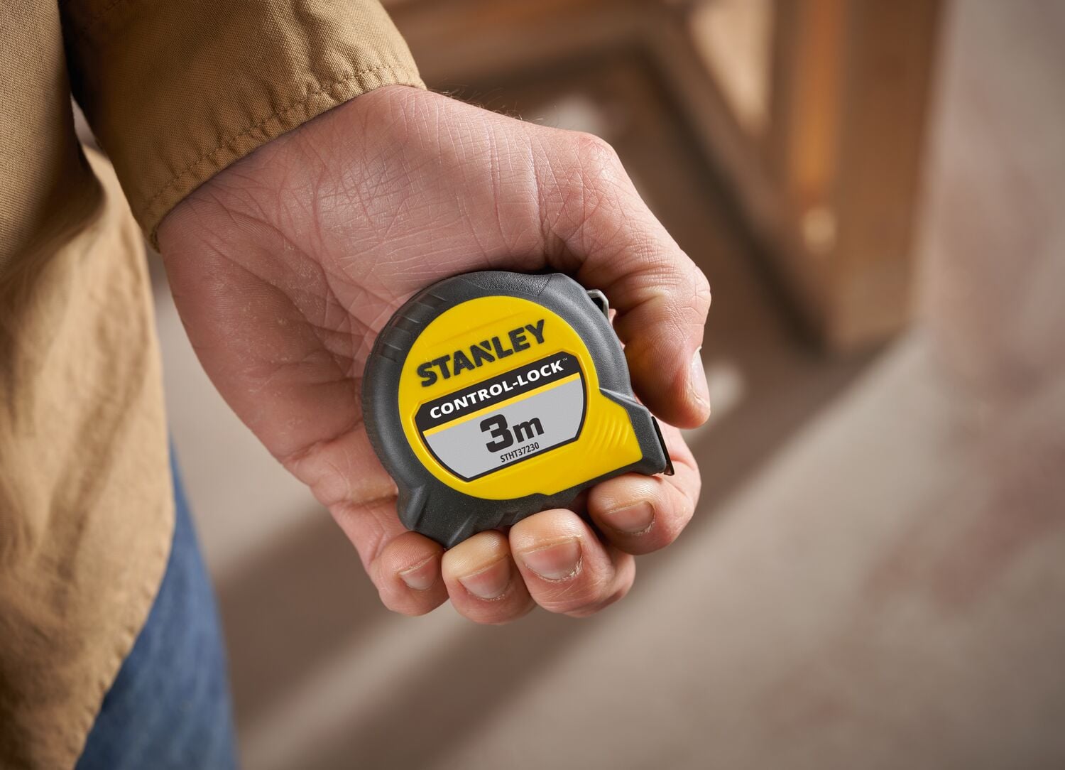 STANLEY® CONTROL-LOCK™ 3M (19mm wide) Tape Measure being held in hand.